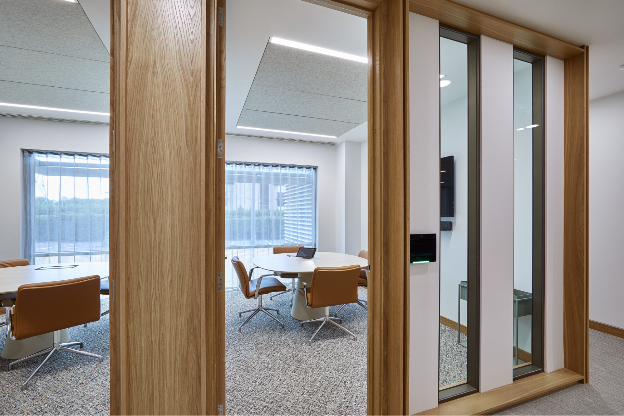 an image of glass doors with natural light and wood frames