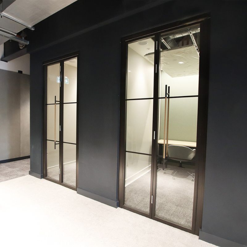 an image of glass office doors that have industrial frames