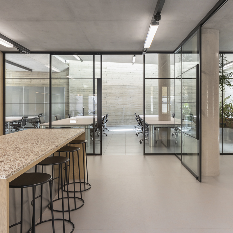 a clean office with industrial glass doors with grid lines