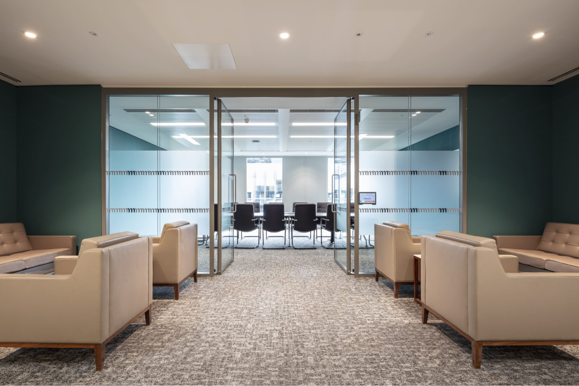 a lawyer office design with glass partition separating a conference and waiting room
