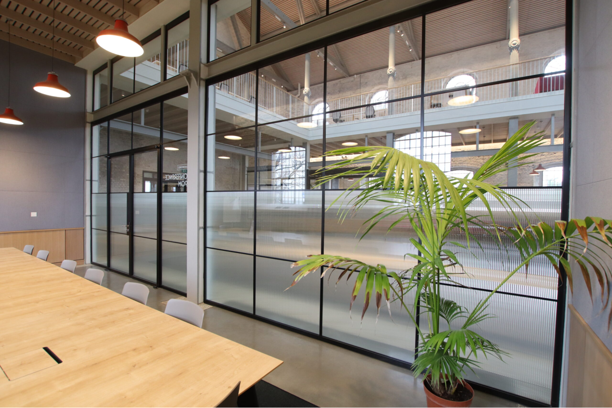 an image of a corporate office interior with a large glass door and window
