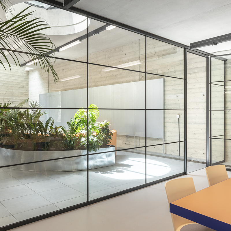 an office with a glass partition wall