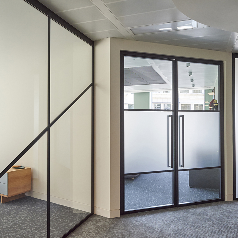 an image of an office space with black framed glass doors and windows